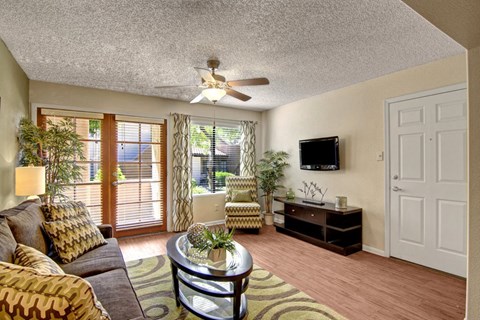 a living room with a couch and a ceiling fan